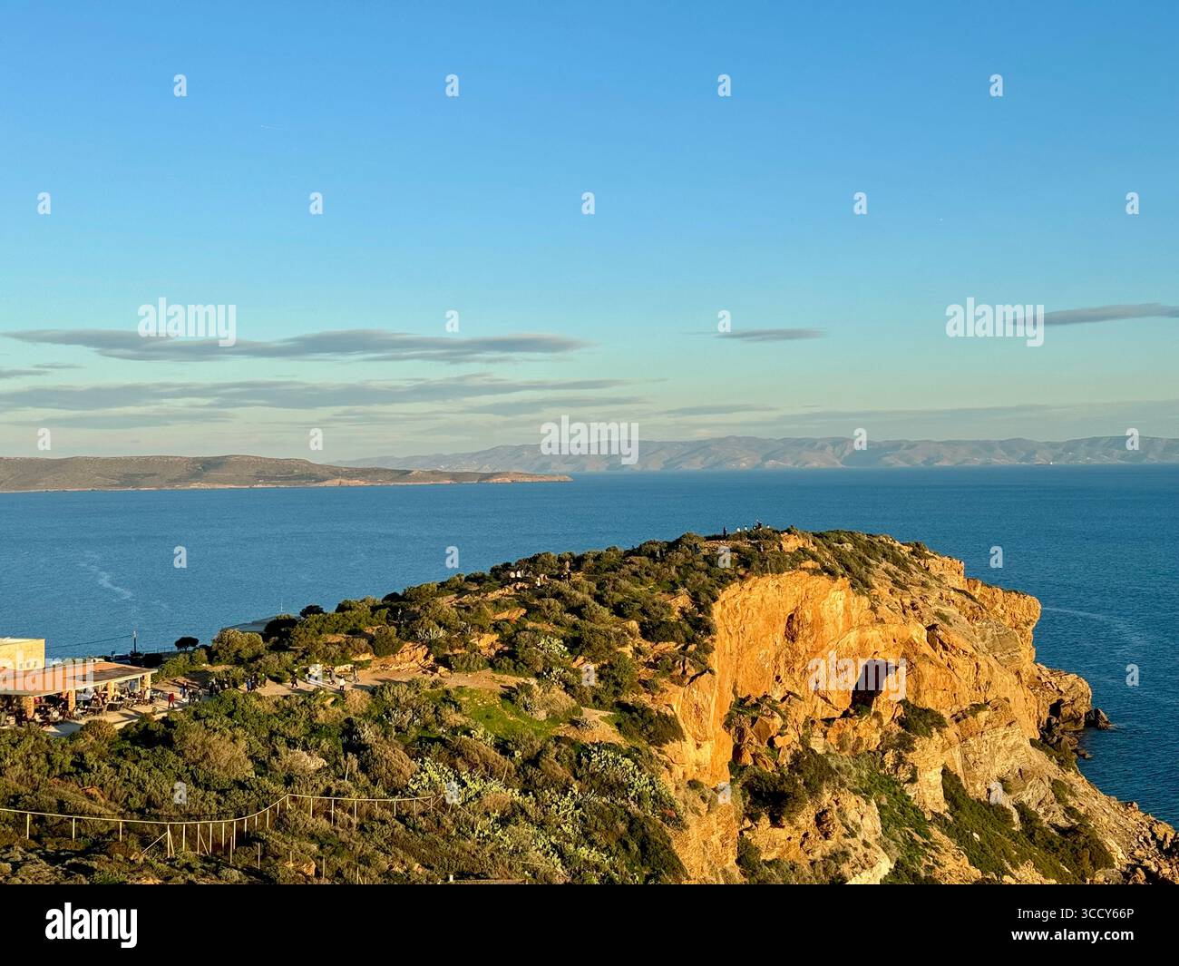 View of Cape Sounion archaeological site with the Temple of Poseidon ruins, Sounion Museum shop, and café/restaurant by the Aegean Sea. - Smartphone Captured Stock Image