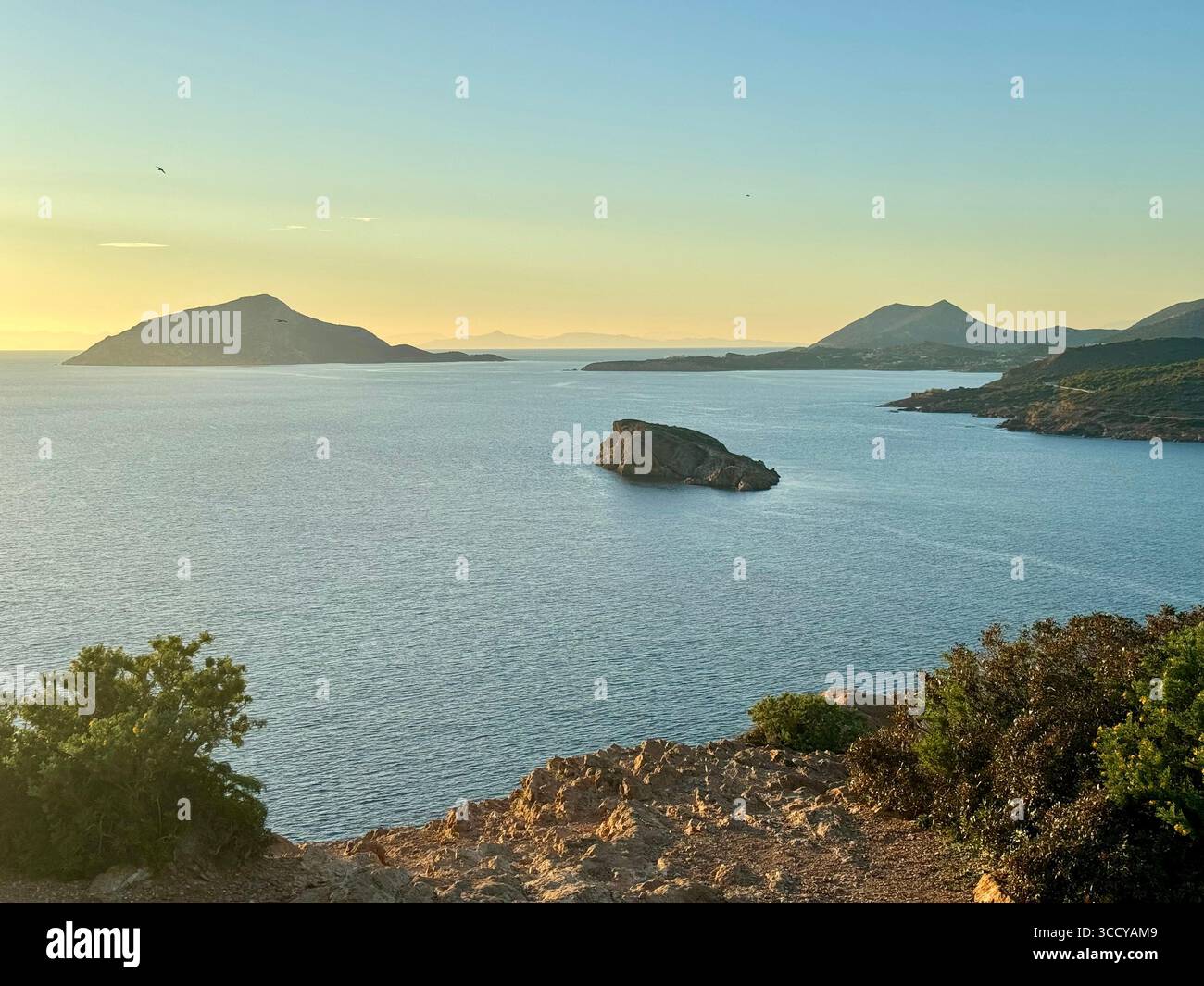 Golden hour sunset over the Aegean Sea at Cape Sounion near the Temple of Poseidon archaeological site. - Smartphone Captured Stock Image