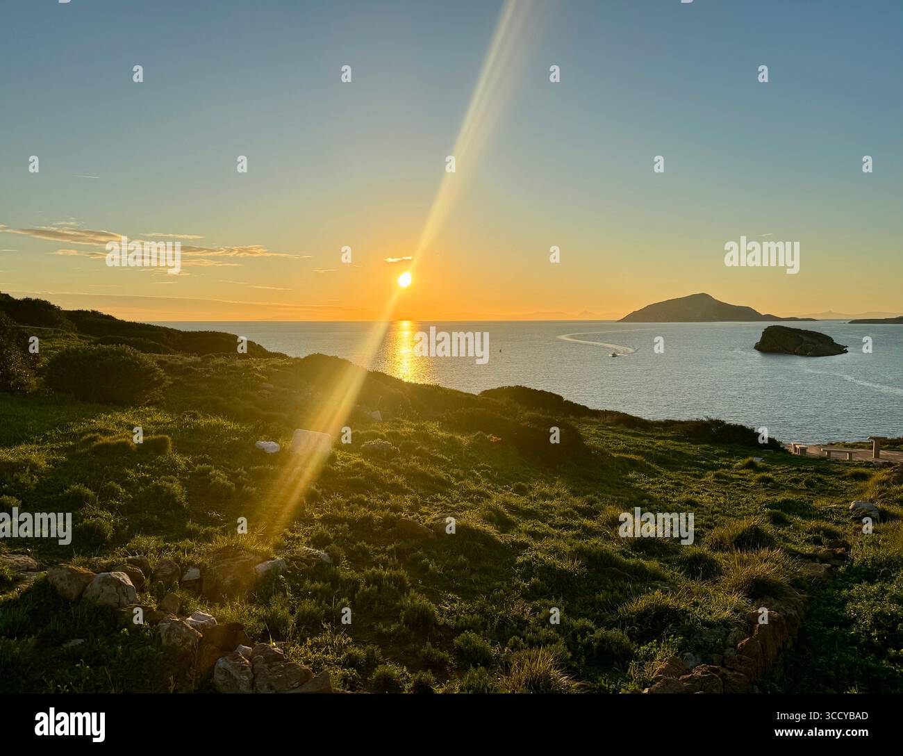 Golden hour light bathes the archaeological site of Sounion, Greece, including pathways and ruins near the Temple of Poseidon. - Smartphone Captured Stock Image