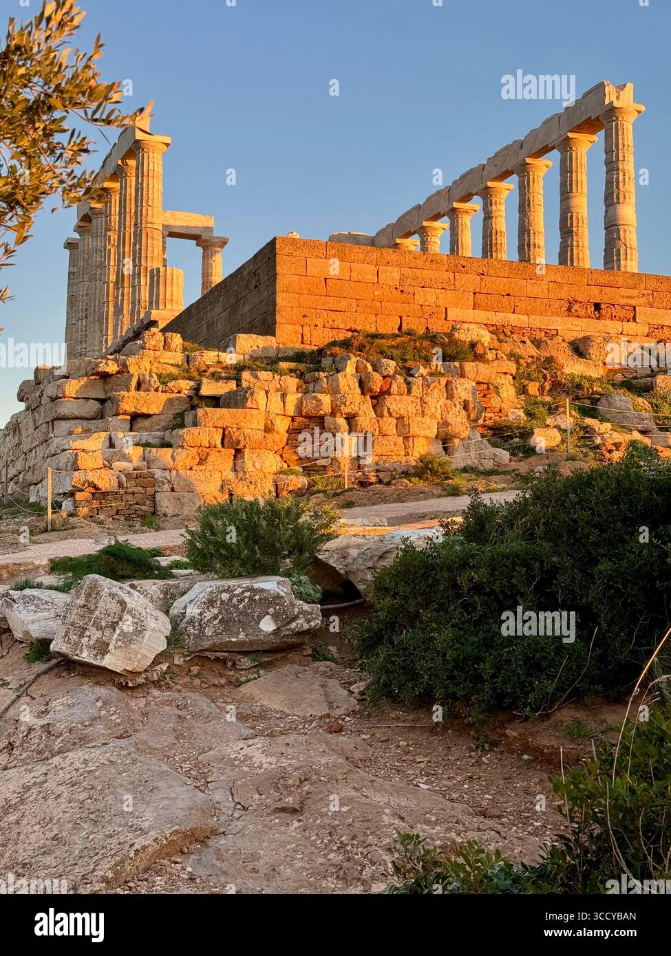 Ancient Temple of Poseidon at Cape Sounion, Greece, illuminated by the warm light of sunset. - Smartphone Captured Stock Image