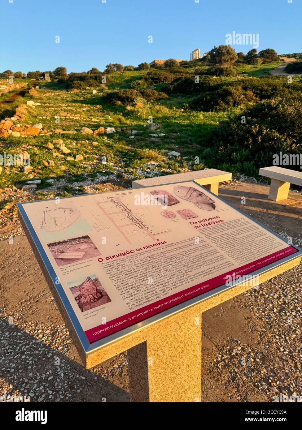 Informative board at golden hour lighting the archaeological site of Sounion, Greece, guiding tourists near the Temple of Poseidon. - Smartphone Captured Stock Image