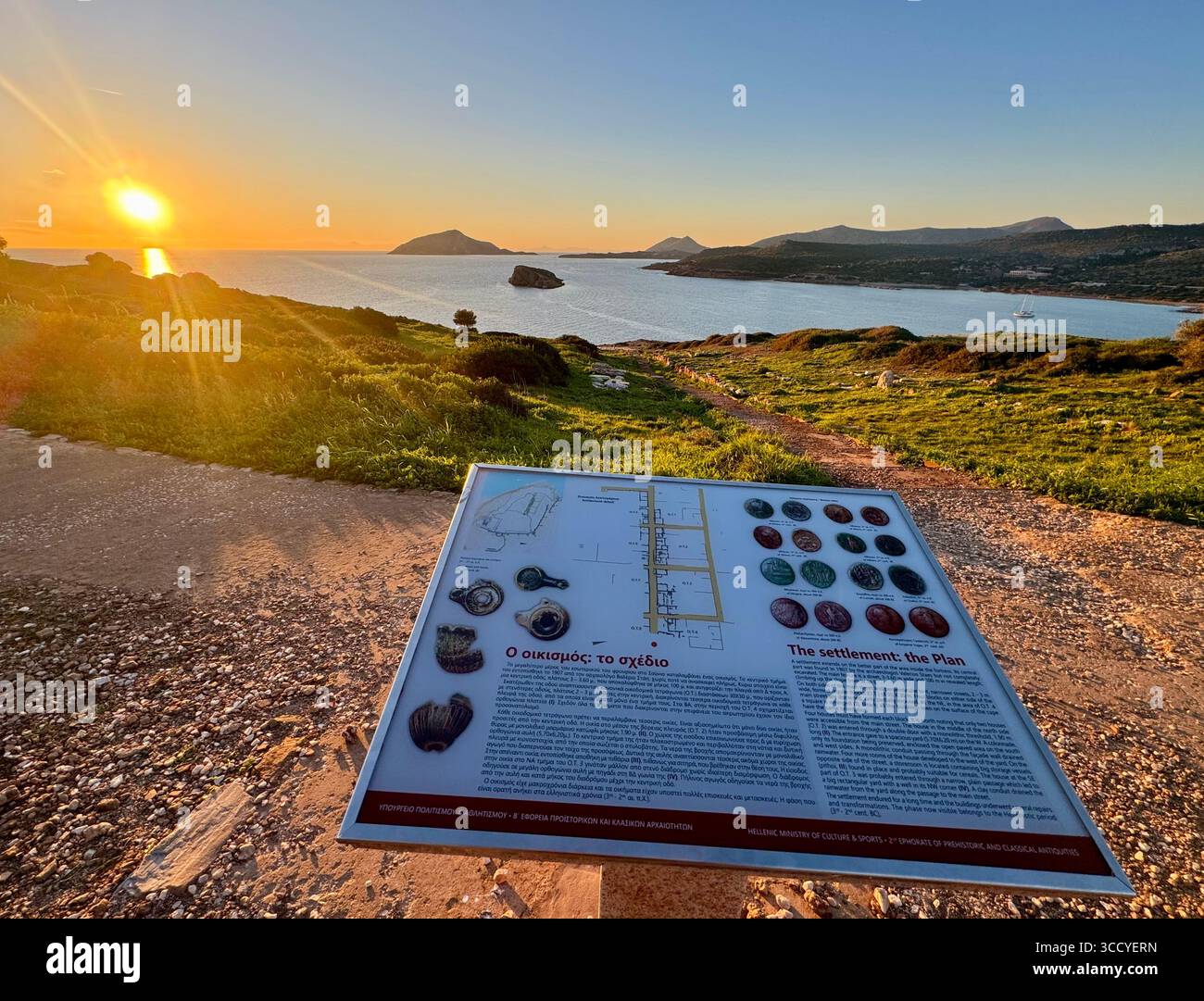 Informative board at golden hour lighting the archaeological site of Sounion, Greece, guiding tourists near the Temple of Poseidon. - Smartphone Captured Stock Image