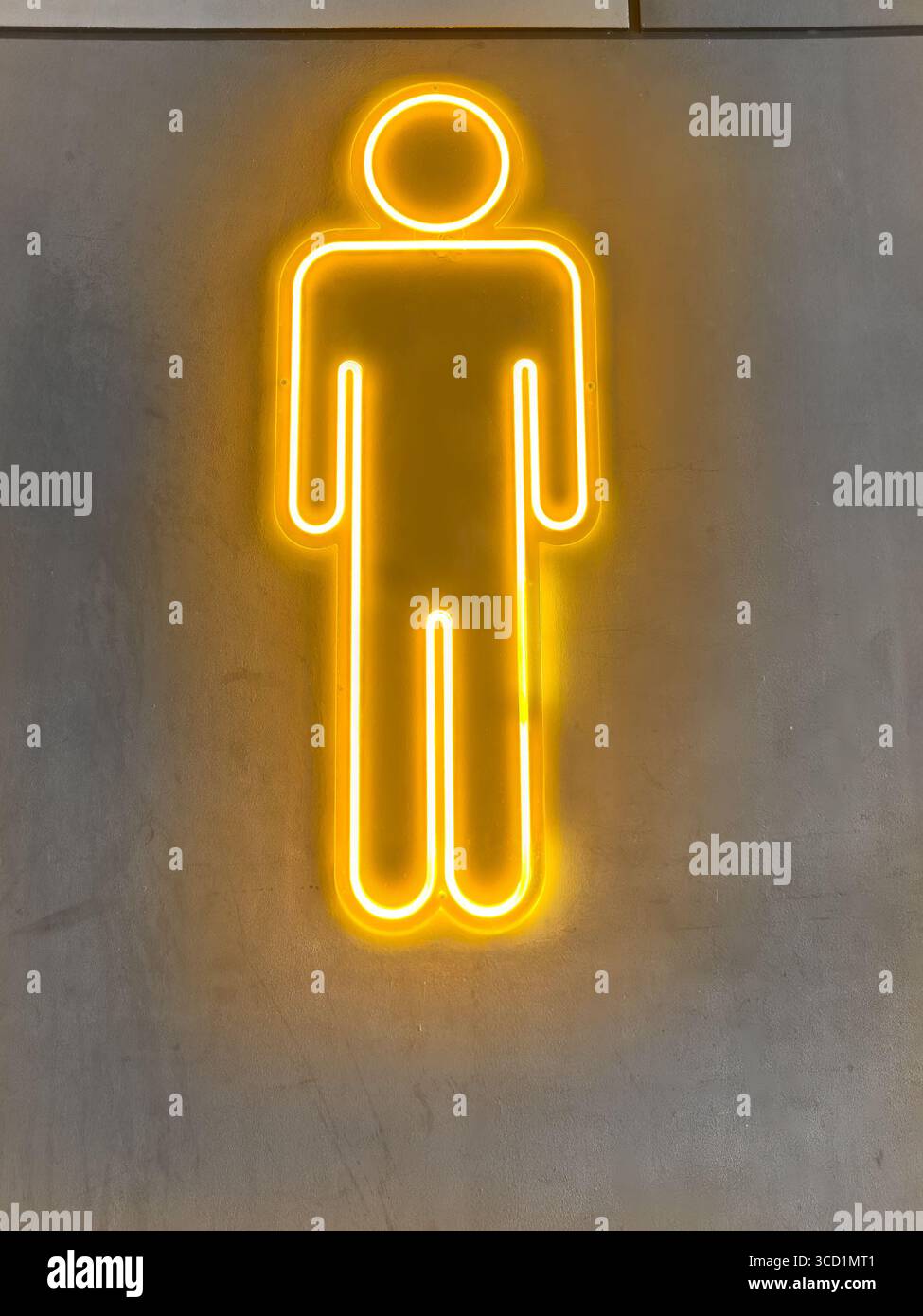 Bright yellow neon light in the shape of a simple male human figure on a gray concrete wall background - restaurant sign for gents male toilets - Smartphone Captured Stock Image