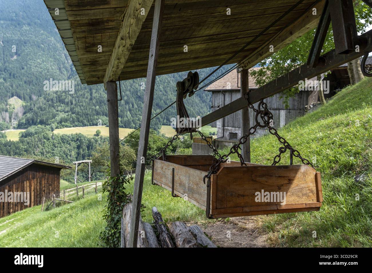 Traditional material ropeway with wooden container on a South Tyrolean ...