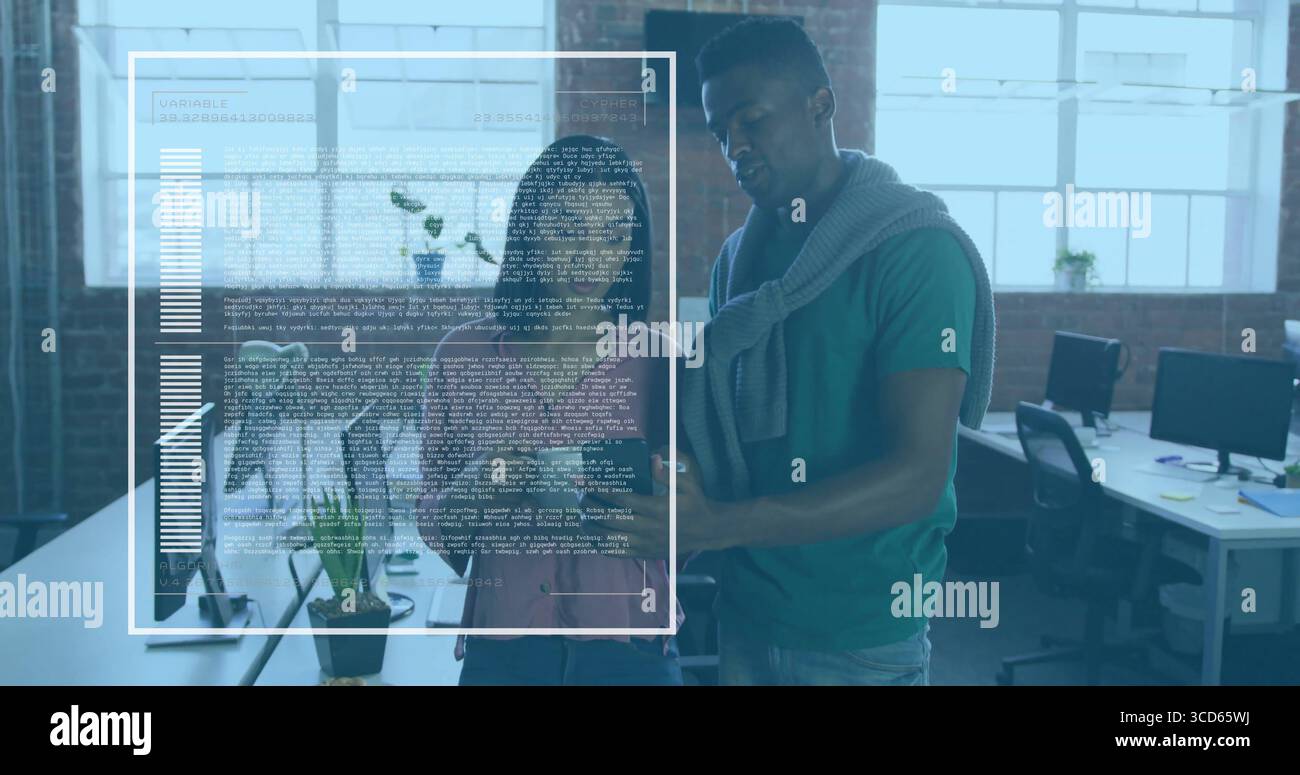 Collaborating software developers reviewing code and charts at open-plan office, with dual monitors Stock Photo