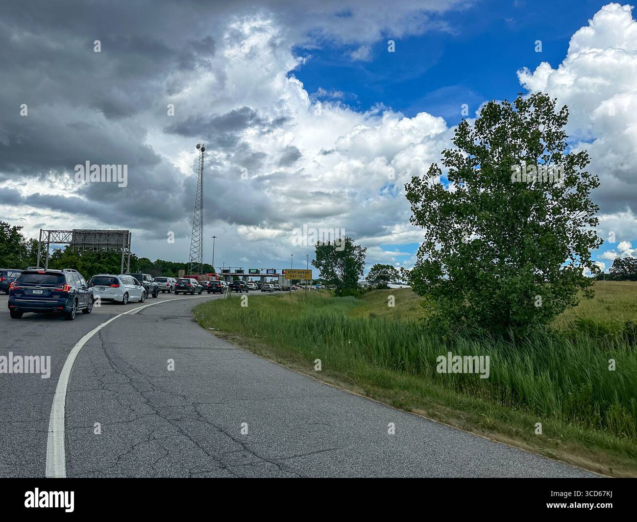 Vehicles waiting in line to go through a toll booth - Smartphone Captured Stock Image