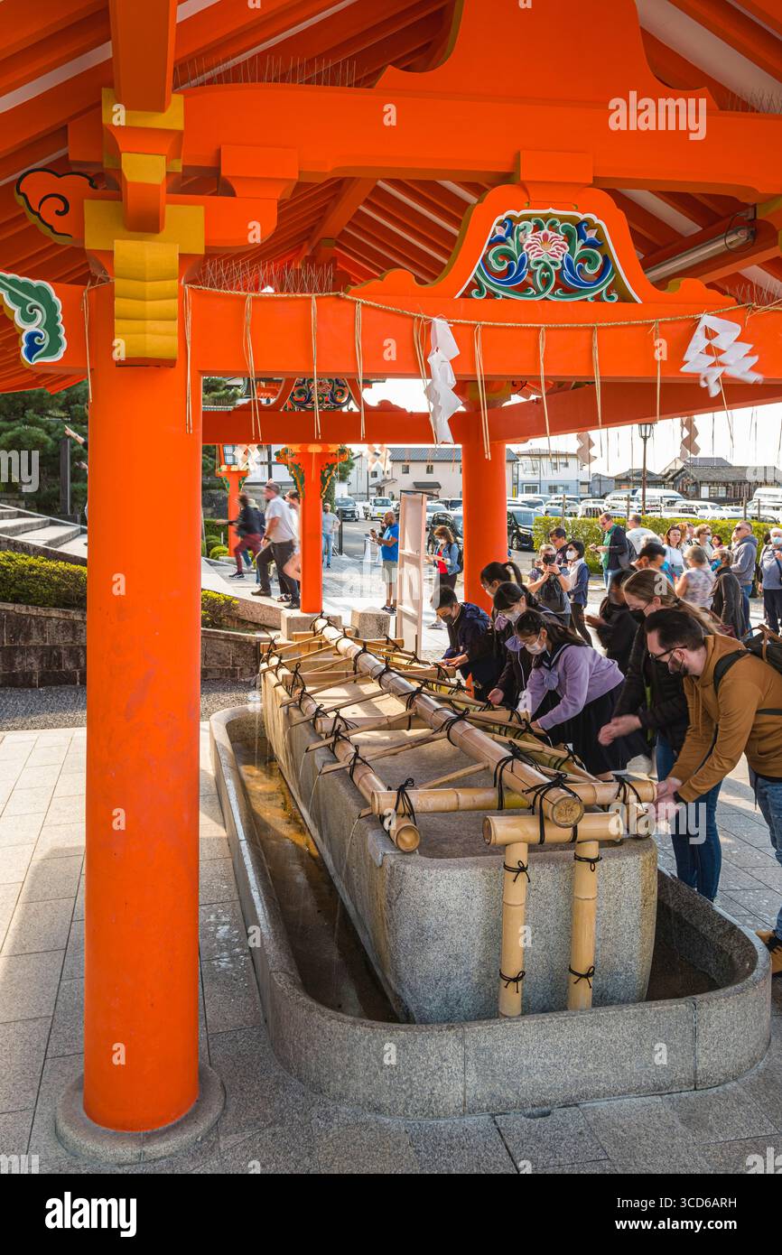 Visitors purifying themselves at hand washing stall before visiting ...