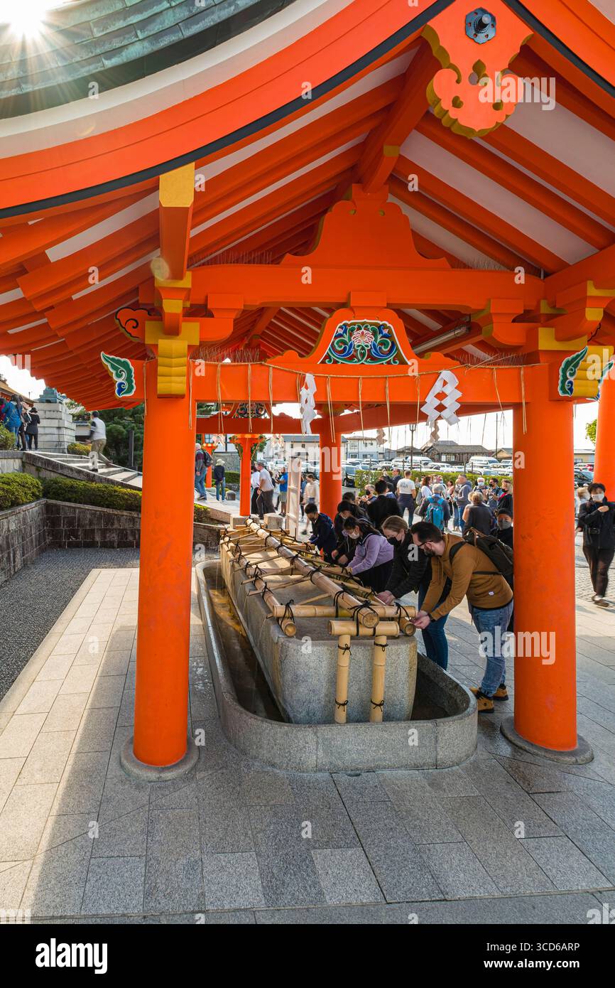 Visitors purifying themselves at hand washing stall before visiting ...