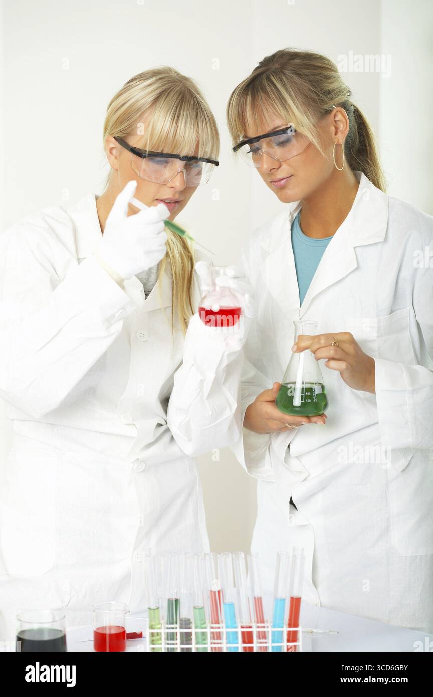 Female lab workers testing and experimenting Stock Photo