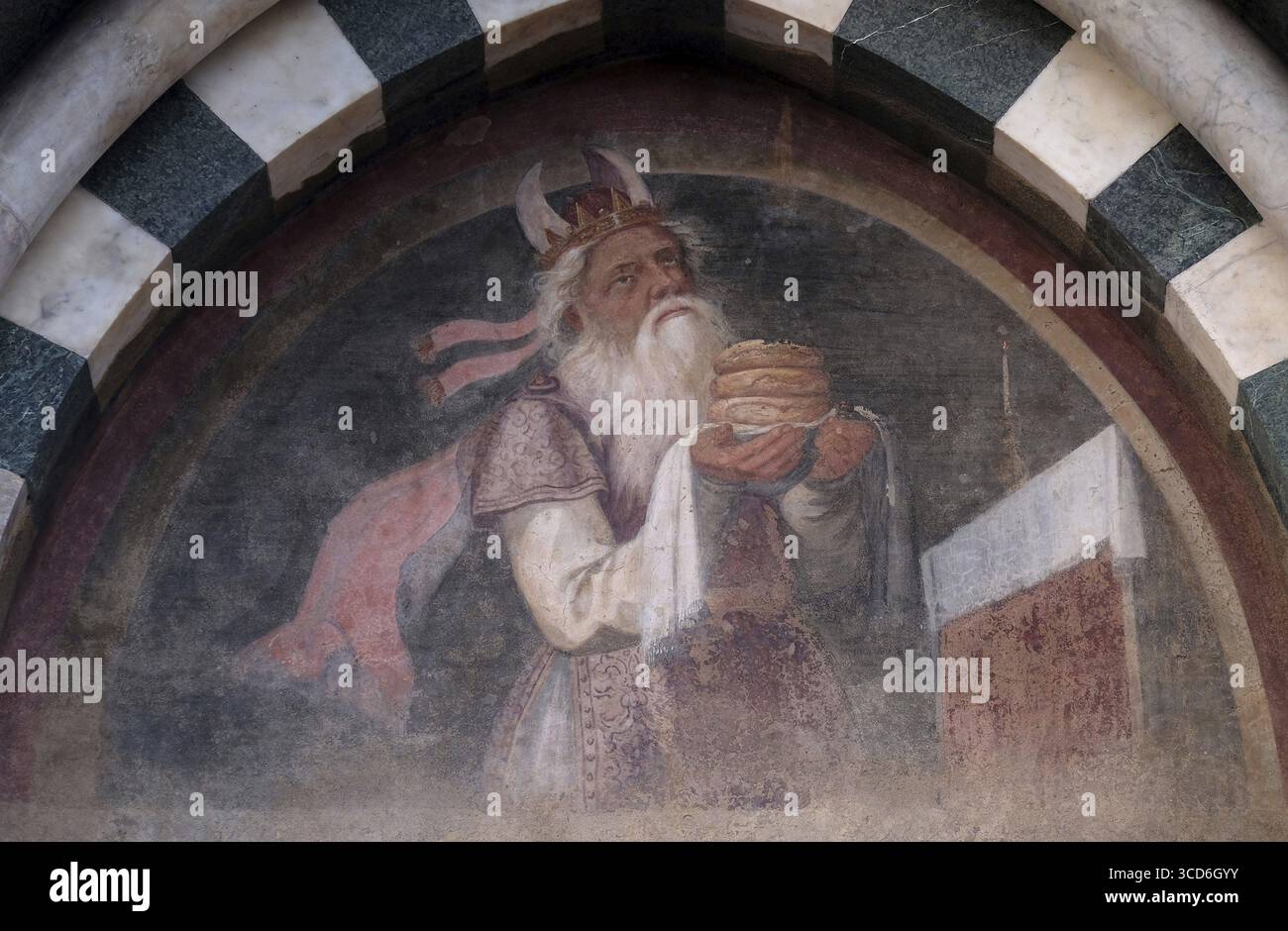 The lunette of one of the side doors depicting Melchizedek, detail of the facade of the Church of Santa Maria Novella in Florence, Italy Stock Photo