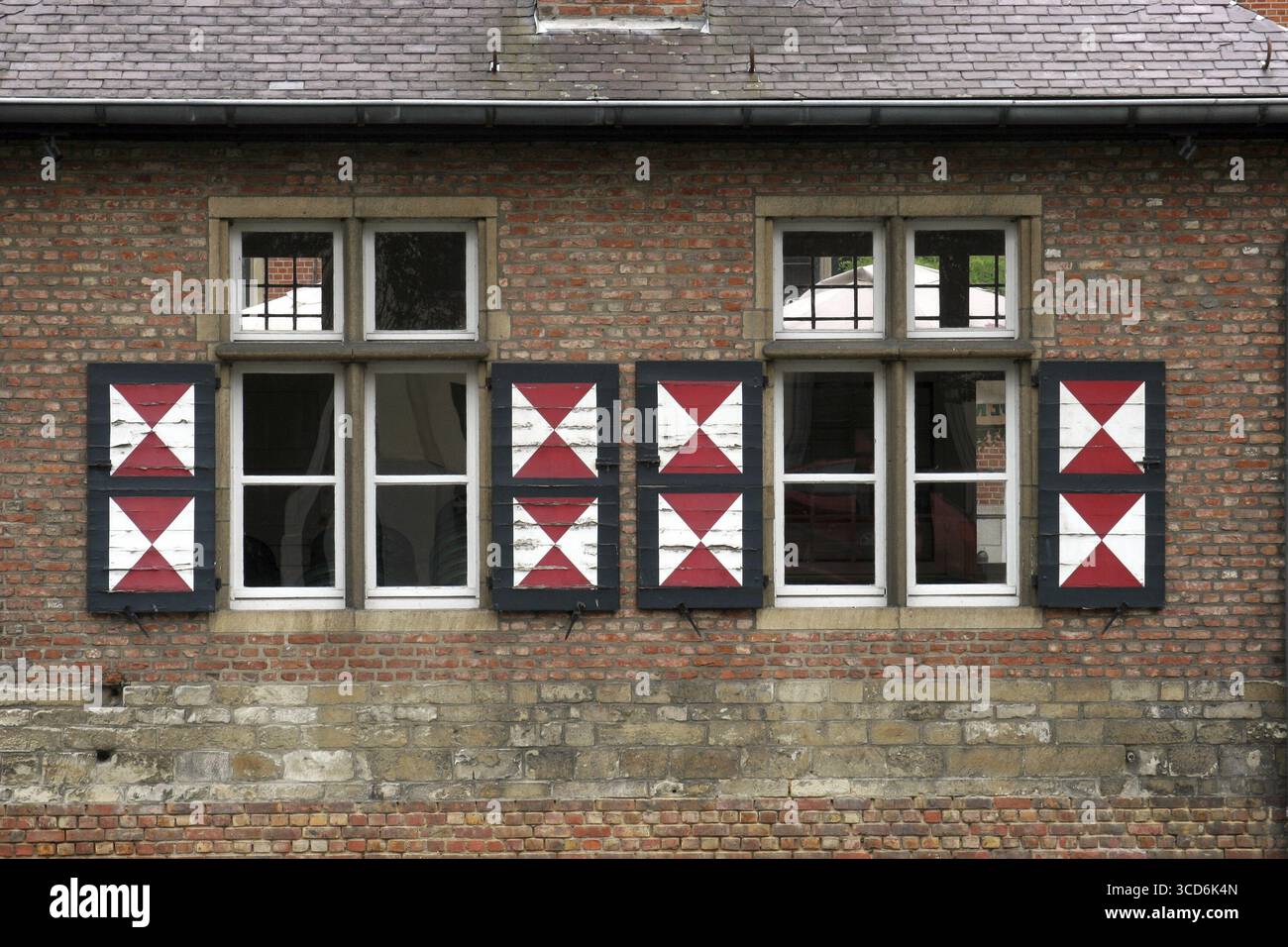 Red brick wall with two windows Stock Photo