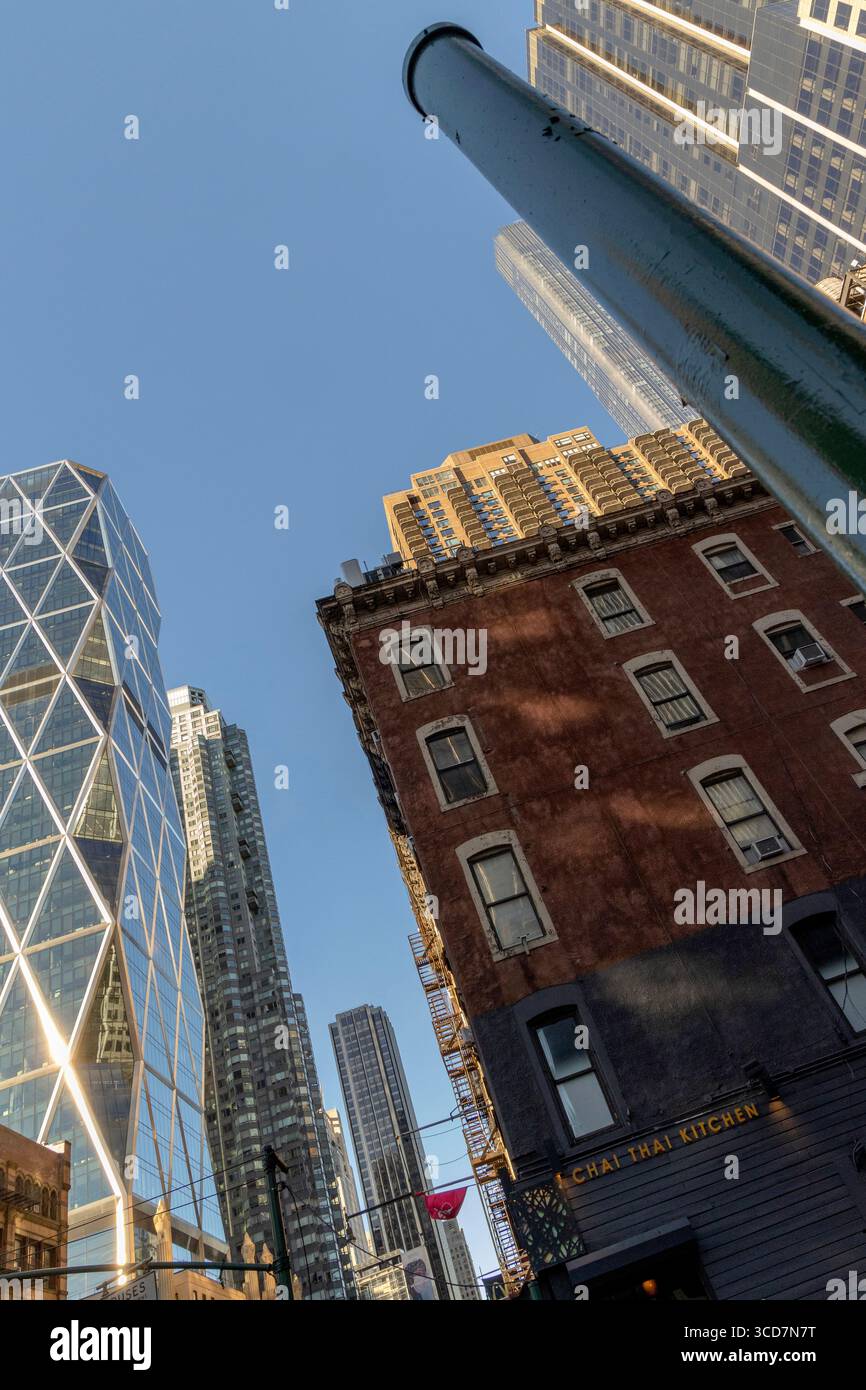 Looking up at Hearst Tower off 8th Avenue, Manhattan, New York City, USA, with modern architecture and urban skyline above Stock Photo