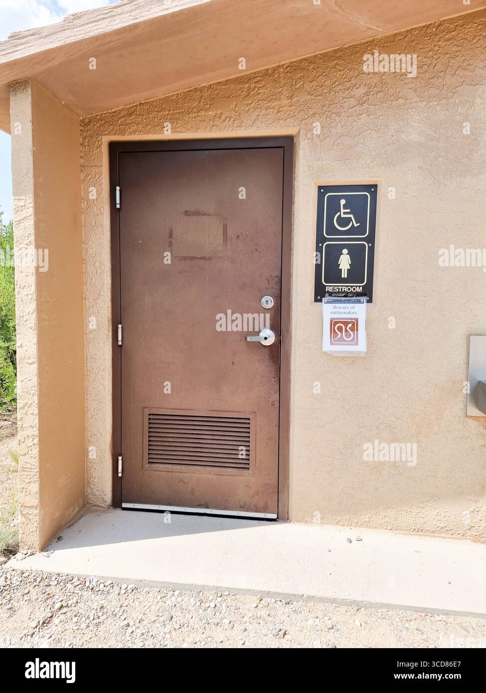 Beware of rattlesnakes; added sign warning for snakes at toilet restroom toilet for women & handicapped - Smartphone Captured Stock Image