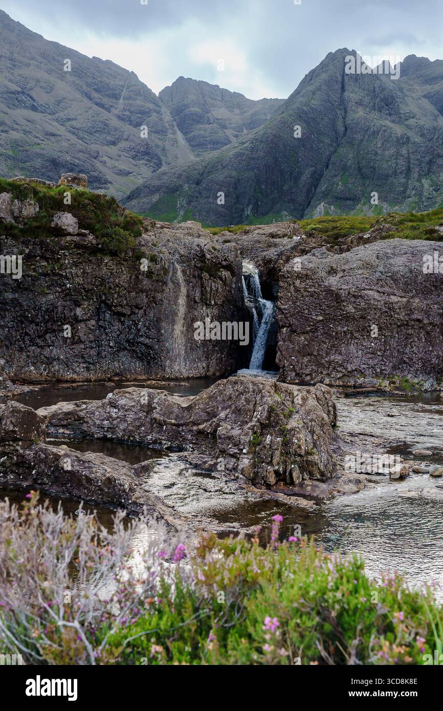 The crystal-clear Fairy Pools in Glen Brittle on the Isle of Skye, Scotland, with waterfalls and the Cuillin mountains in the background. Stock Photo