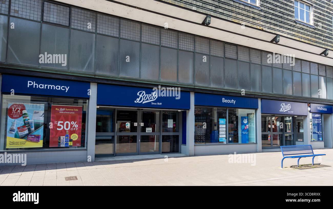 Exterior view of a Boots store with signs for pharmacy, beauty, and wellness sections on a sunny day Devizes Wiltshire UK Stock Photo