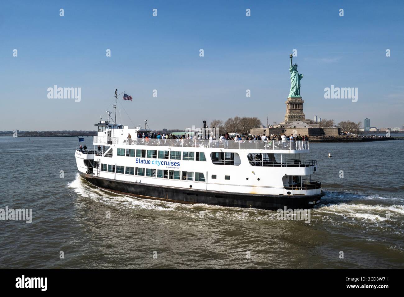 view of the Statue City Cruise boat and the Statue of Liberty in New York Habour Stock Photo