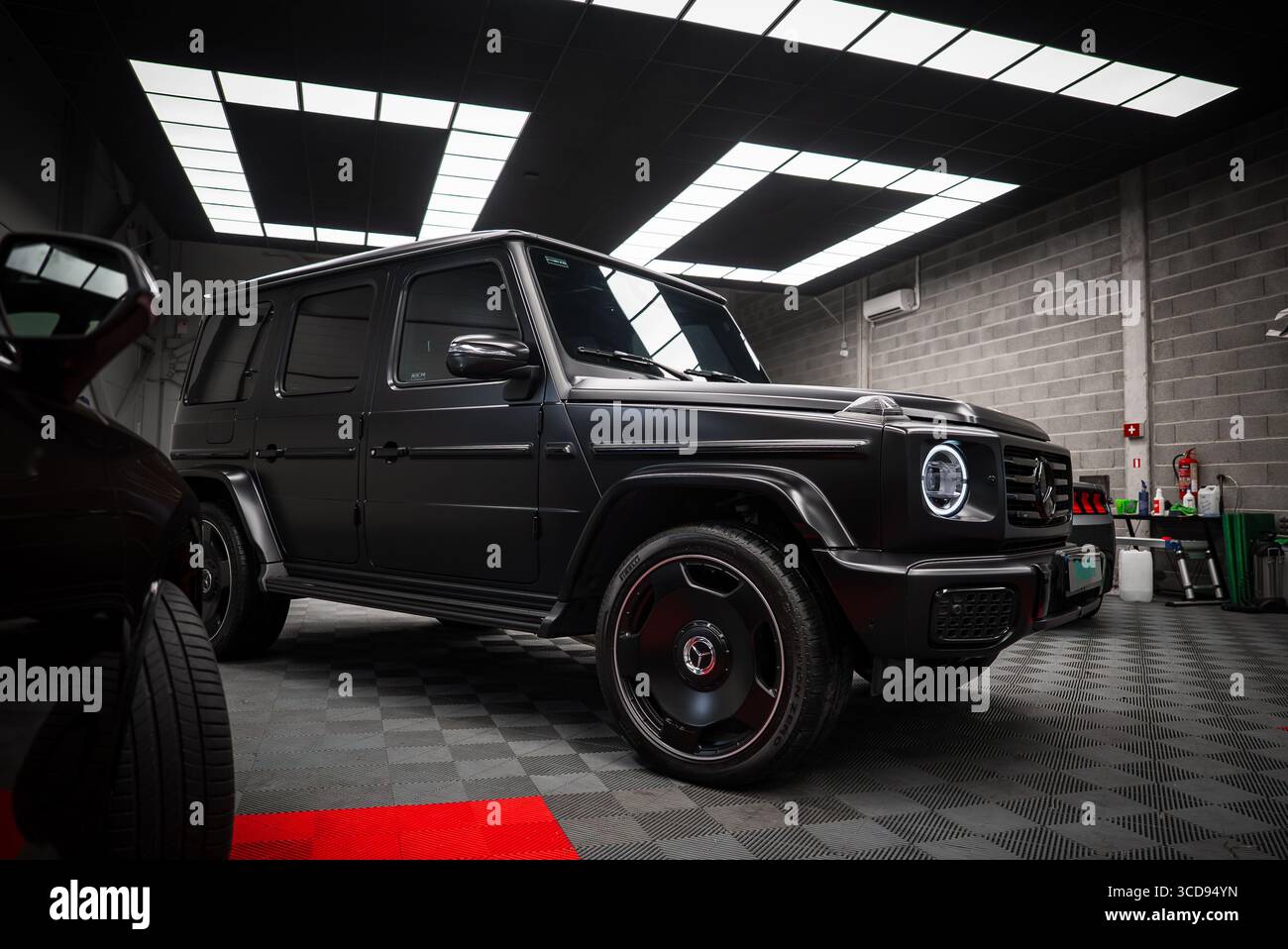 Matte Black Mercedes AMG G Class SUV in Modern Showroom Setting Stock ...