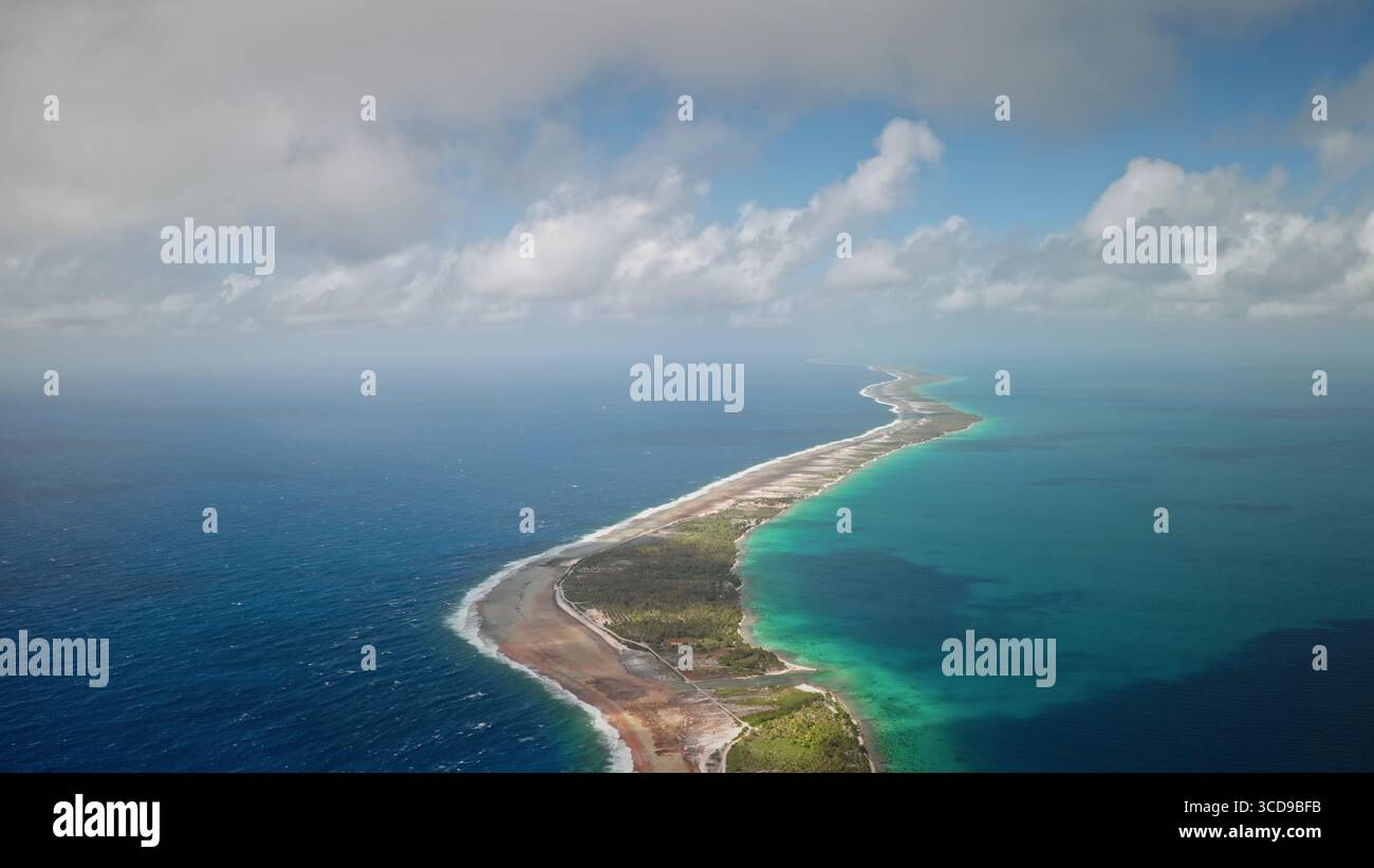 French Polynesia, Rangiroa island: narrow landmass and turquoise water ...