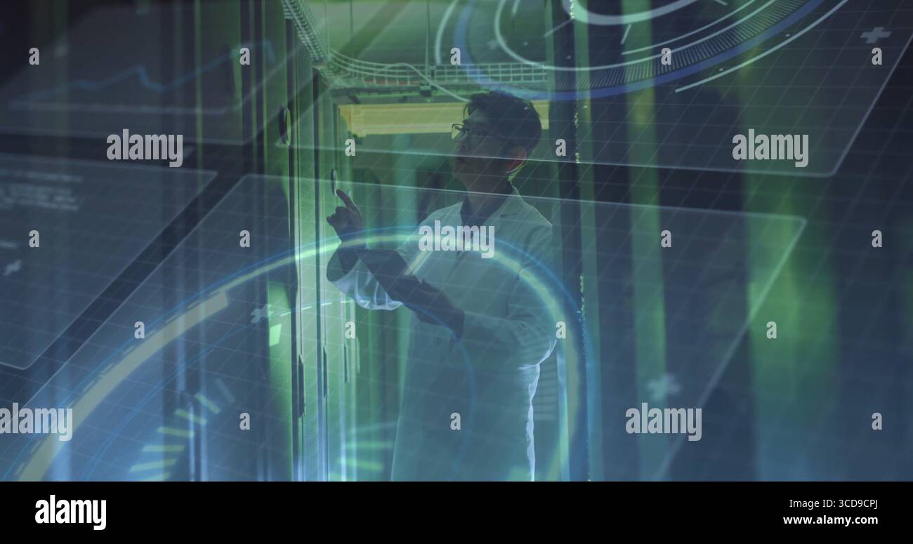 Pointing man wearing white lab coat checking server modules in data center, with HUD graphics Stock Photo