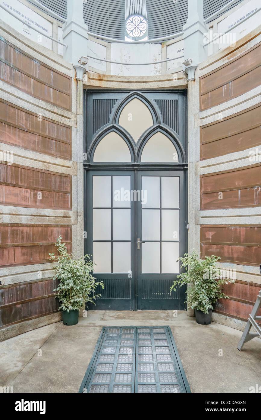 Entrance Of Municipal Burial Monument At Agramonte Cemetery Porto. Stone pathway, greenery, historic architecture, cultural heritage site Stock Photo