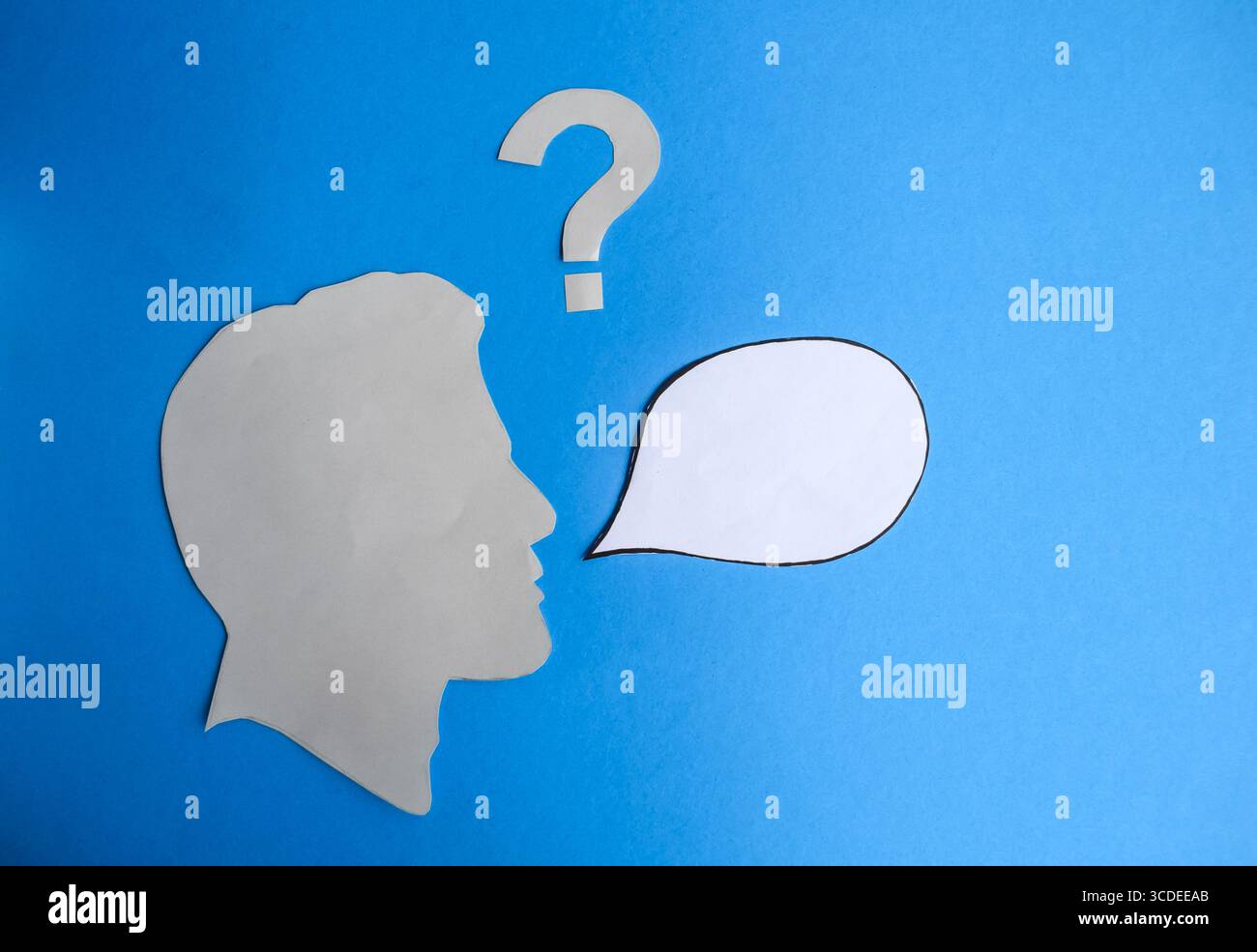 Human Head Silhouette with Blank Speech Bubble and Question Mark Stock Photo