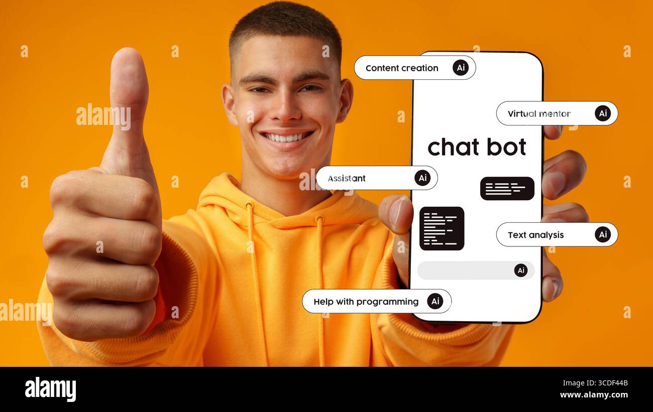Young man showcasing chatbot features on mobile device against bright orange background emphasizing virtual assistance tools Stock Photo