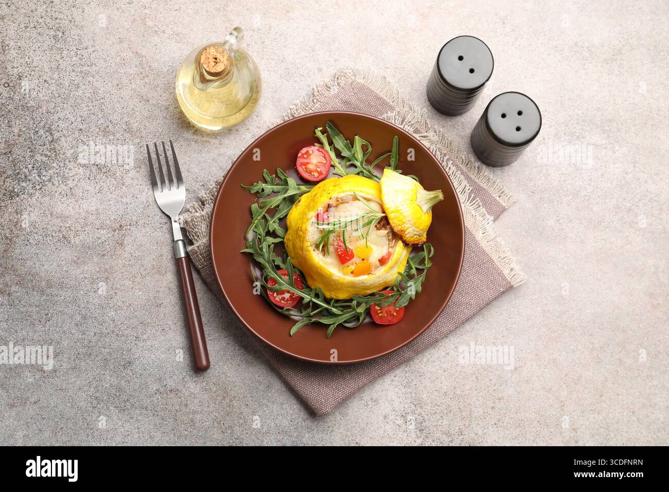 Tasty stuffed pattypan squash with tomatoes and arugula served on grey table, flat lay Stock Photo