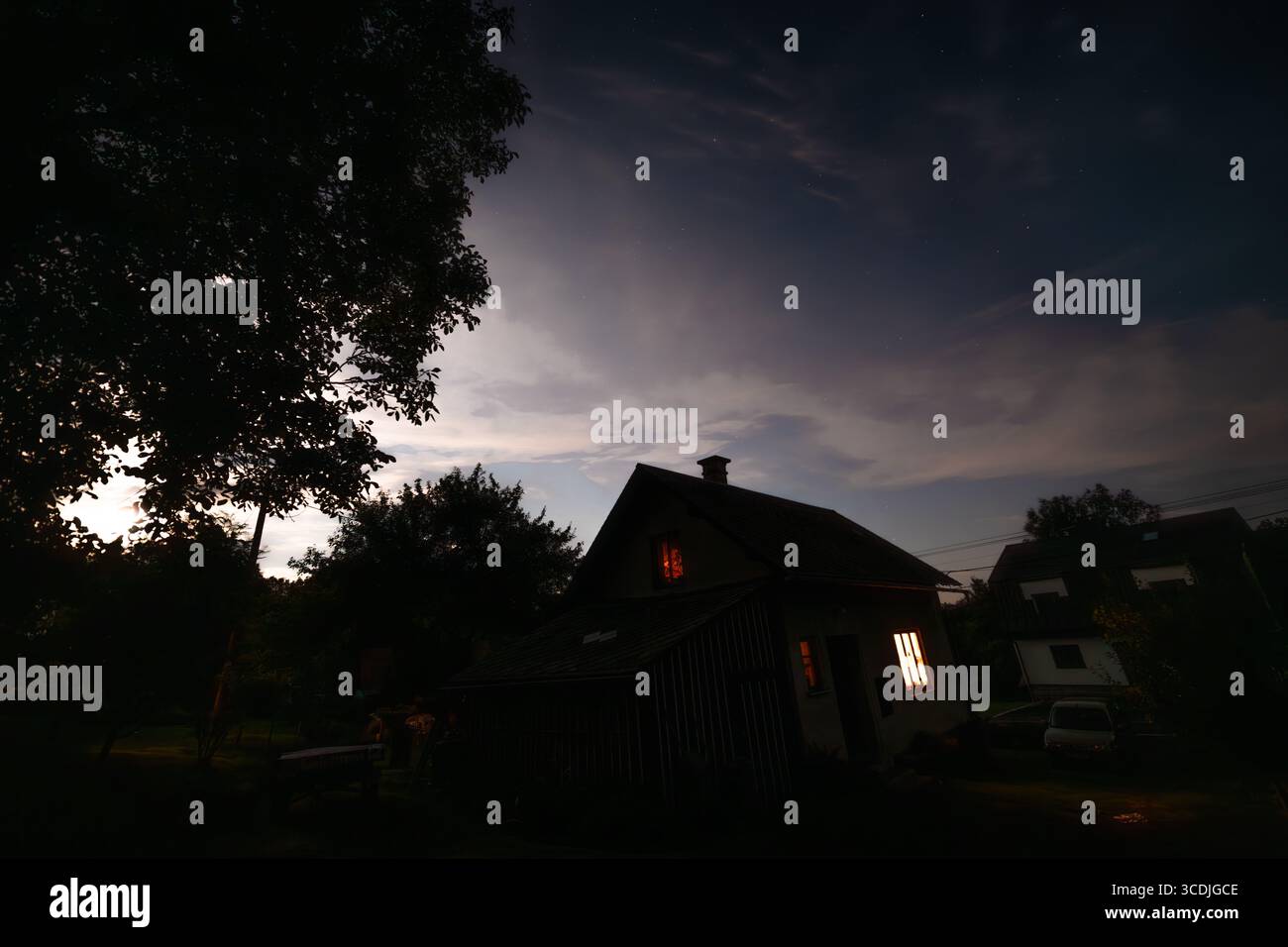 Silhouette of village small house with moon stars heaven in Roprachtice CZ 08 08 2025 Stock Photo