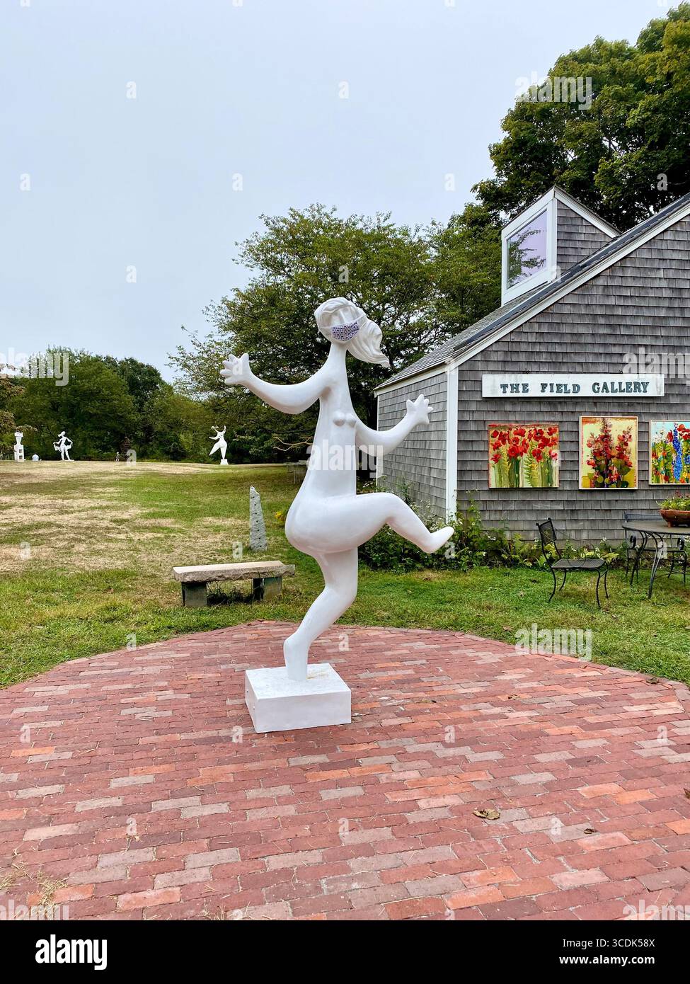 As places re-opened to the public after Covid 19 shut-downs, a dancing sculpture is seen clad in a face mask at The Field Gallery on the Vineyard. - Smartphone Captured Stock Image