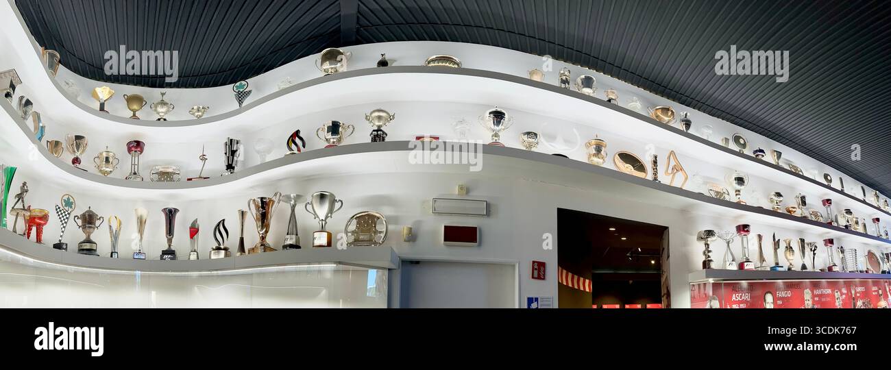 Wide display of Formula 1 race trophies displayed at the Museo Ferrari in Maranello. - Smartphone Captured Stock Image