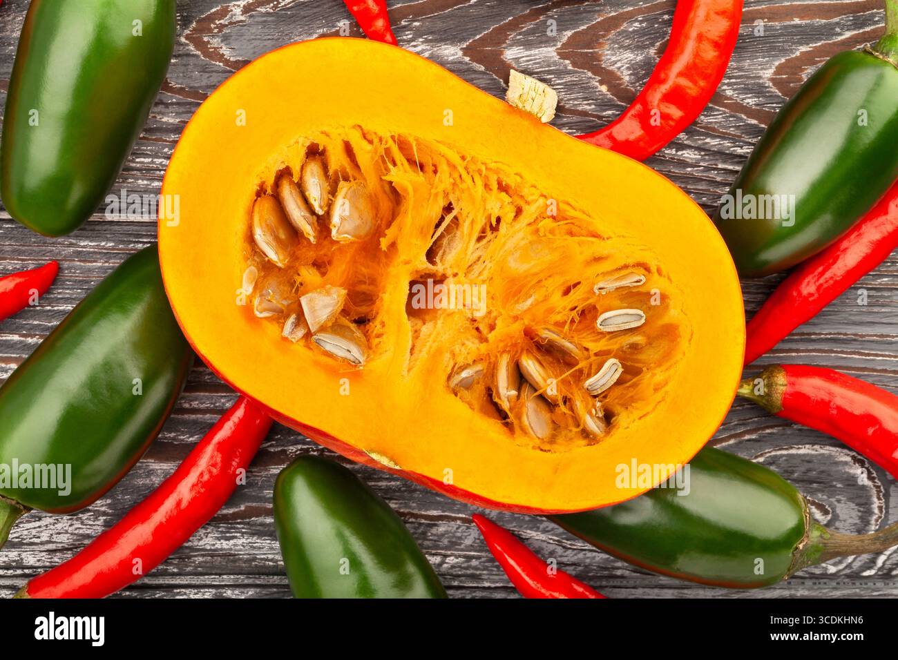 sliced kuri squash on wood background top view Stock Photo