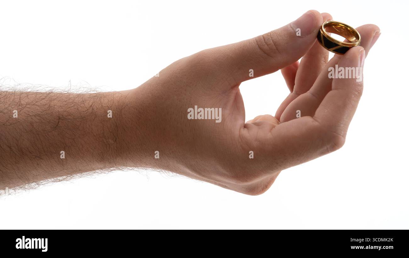 Holding a gold wedding band in hand, symbolizing love and commitment ...