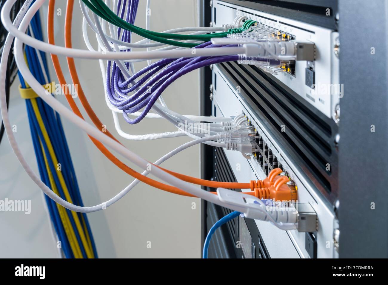 SFP+ 10 Gbps Direct Attach Cable plugged into 10GbE SFP+ port on a UniFi Switch Pro 24 PoE Stock Photo
