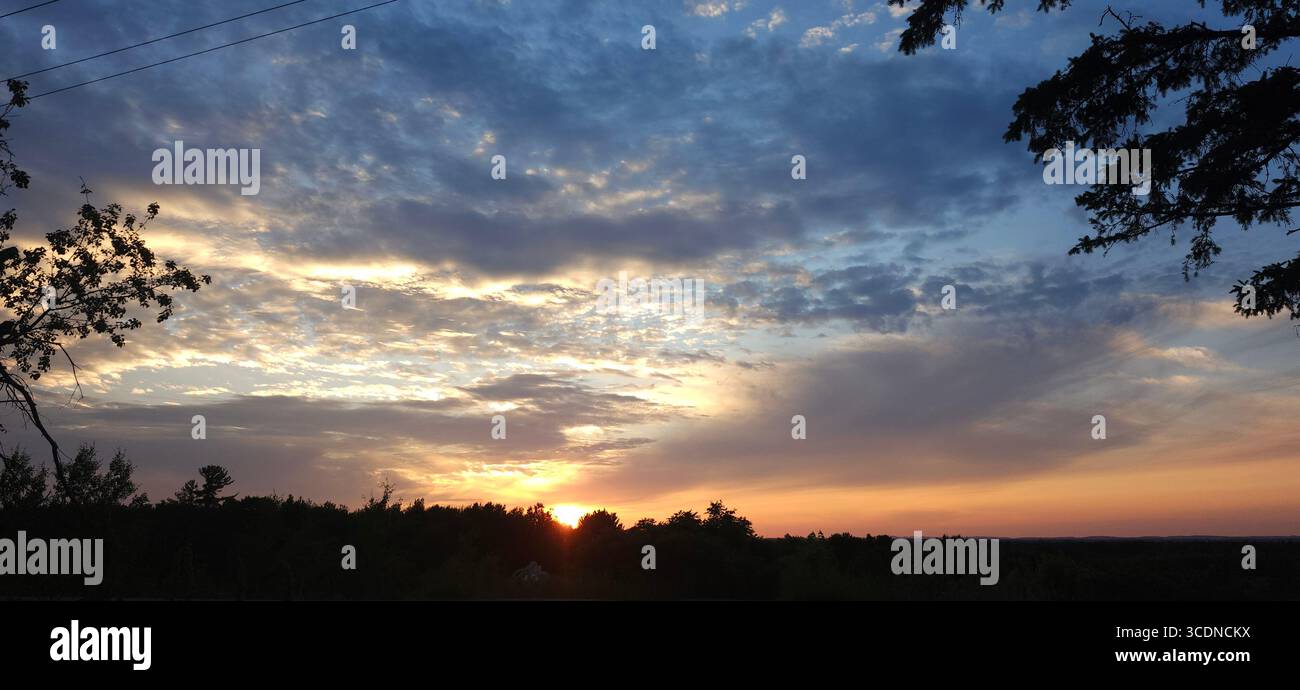 This moment tranquility captures the essence of a day gracefully coming to a close, a fleeting reminder of the profound beauty found in nature. - Smartphone Captured Stock Image