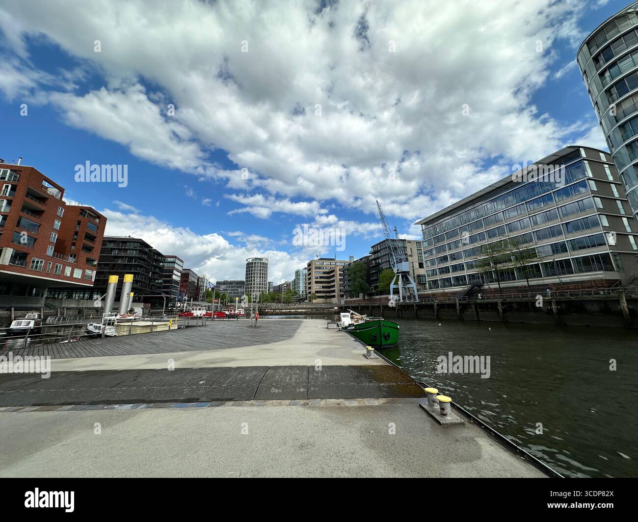 Hamburg, Germany: Modern waterfront architecture and moored boats at the Sandtorhafen (Traditional Ship Harbour) in the HafenCity district - Smartphone Captured Stock Image