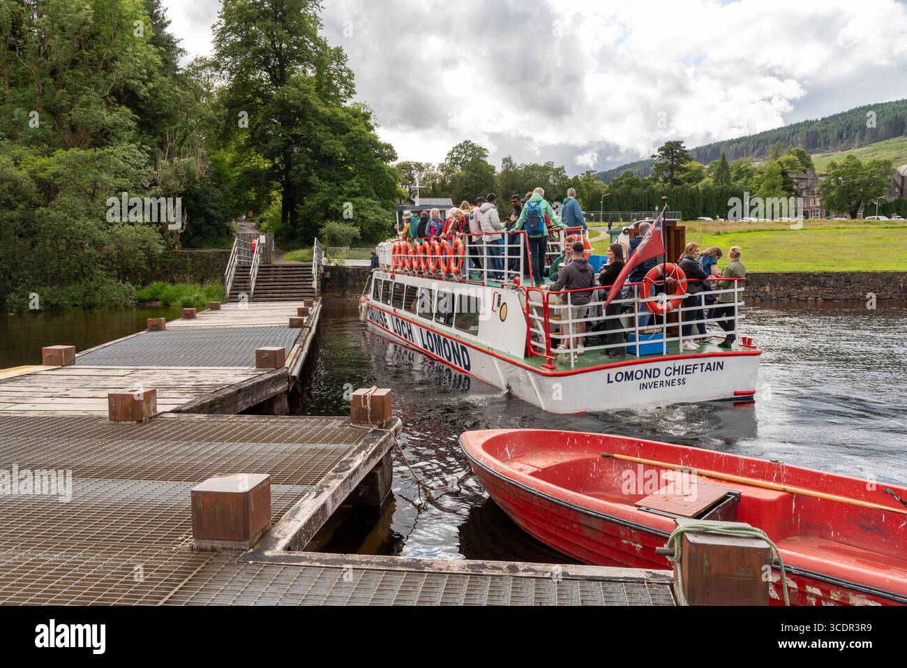 Tarbet Argyll and Bute Scotland UK. 06.07.2025. Pier with a pleasure boat and passengers docking at Tarbet on the west shores of Loch Lomond Scotland Stock Photo