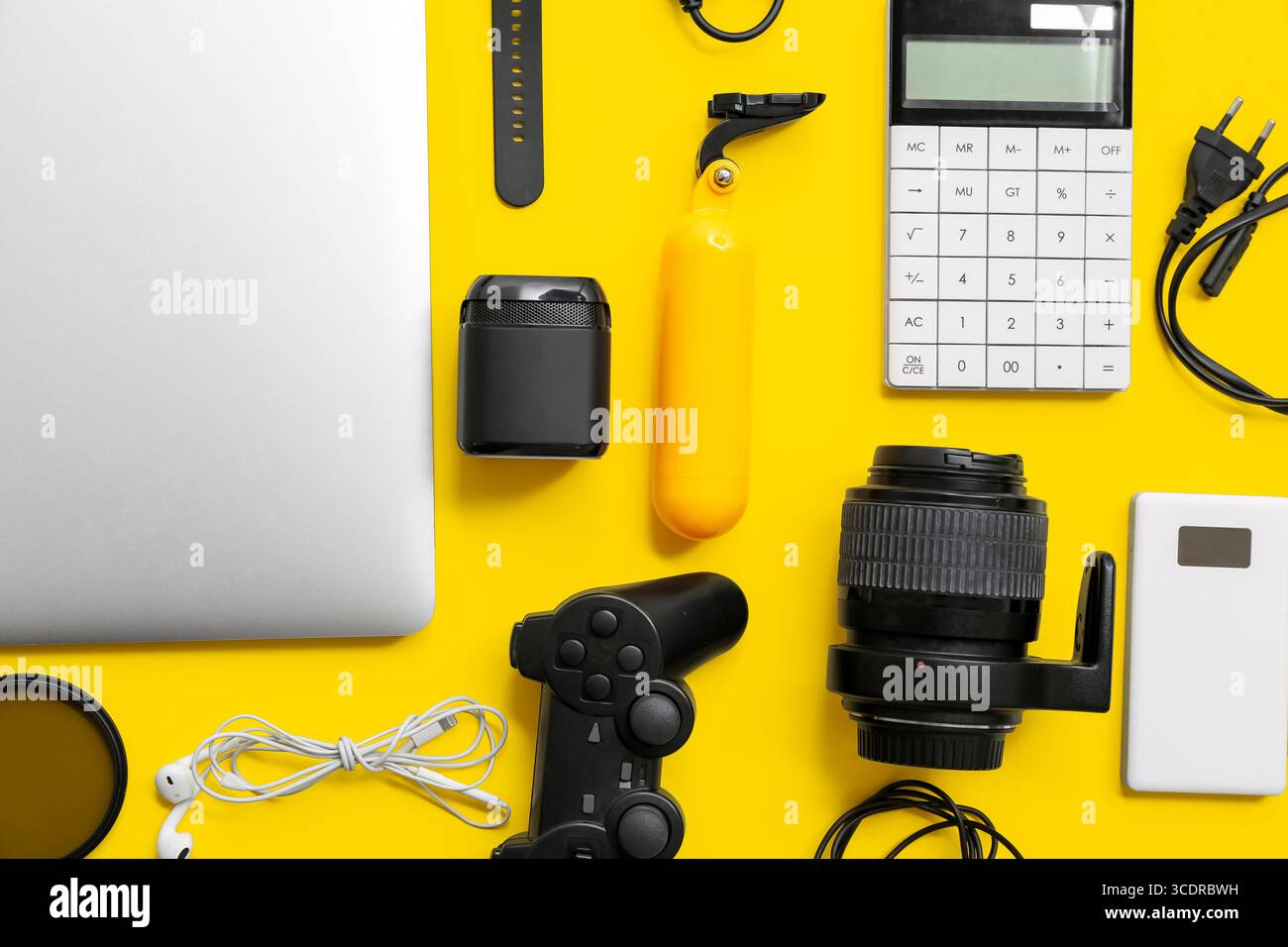 Composition with modern gadgets on yellow background Stock Photo