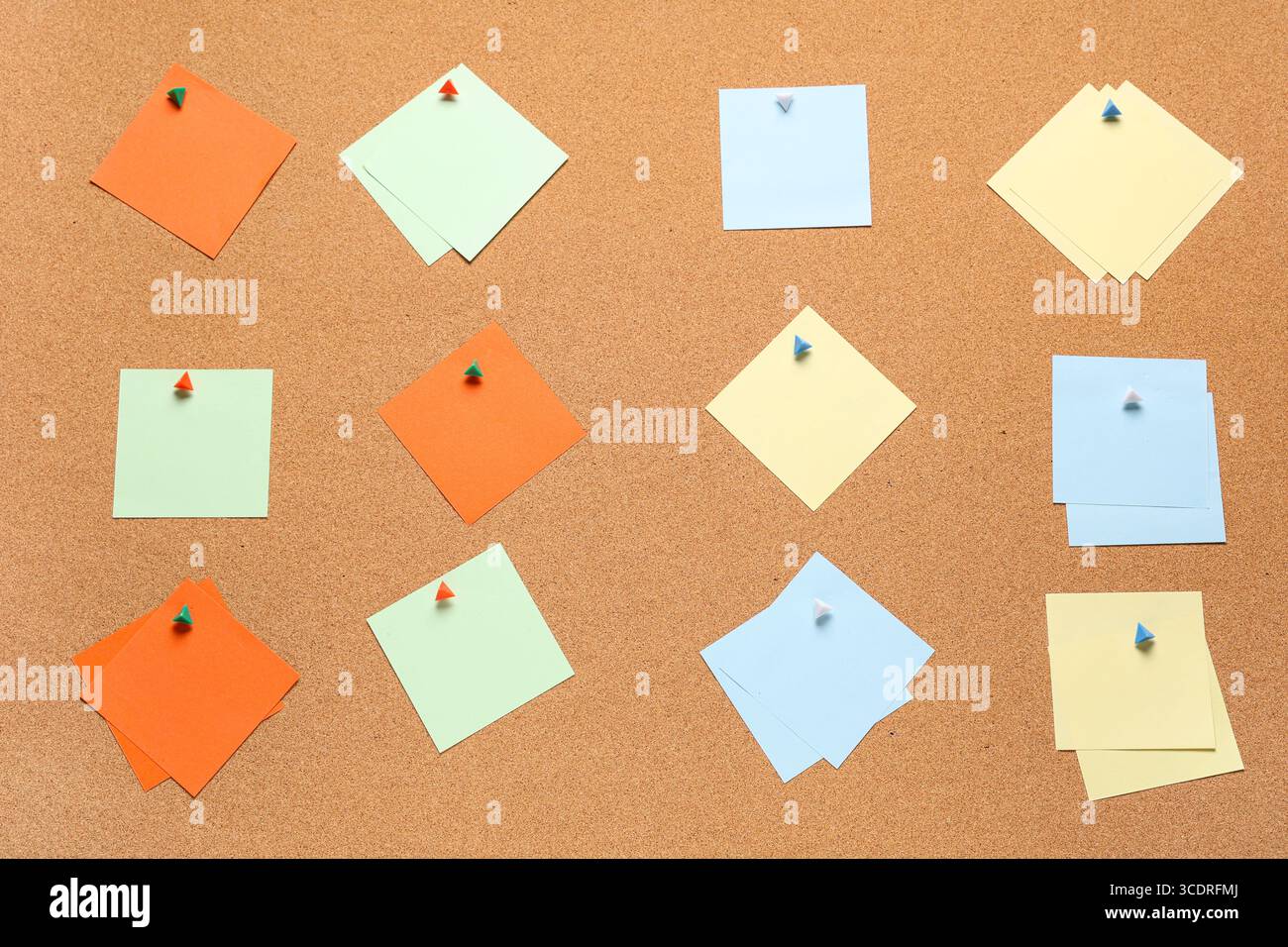 Blank sticky notes with pins on cork board as background Stock Photo