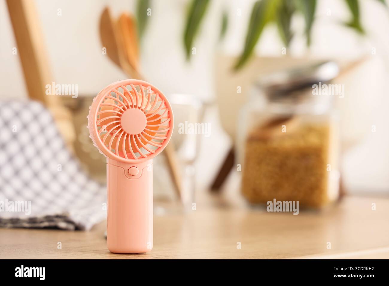 Mini fan on counter in kitchen, closeup Stock Photo