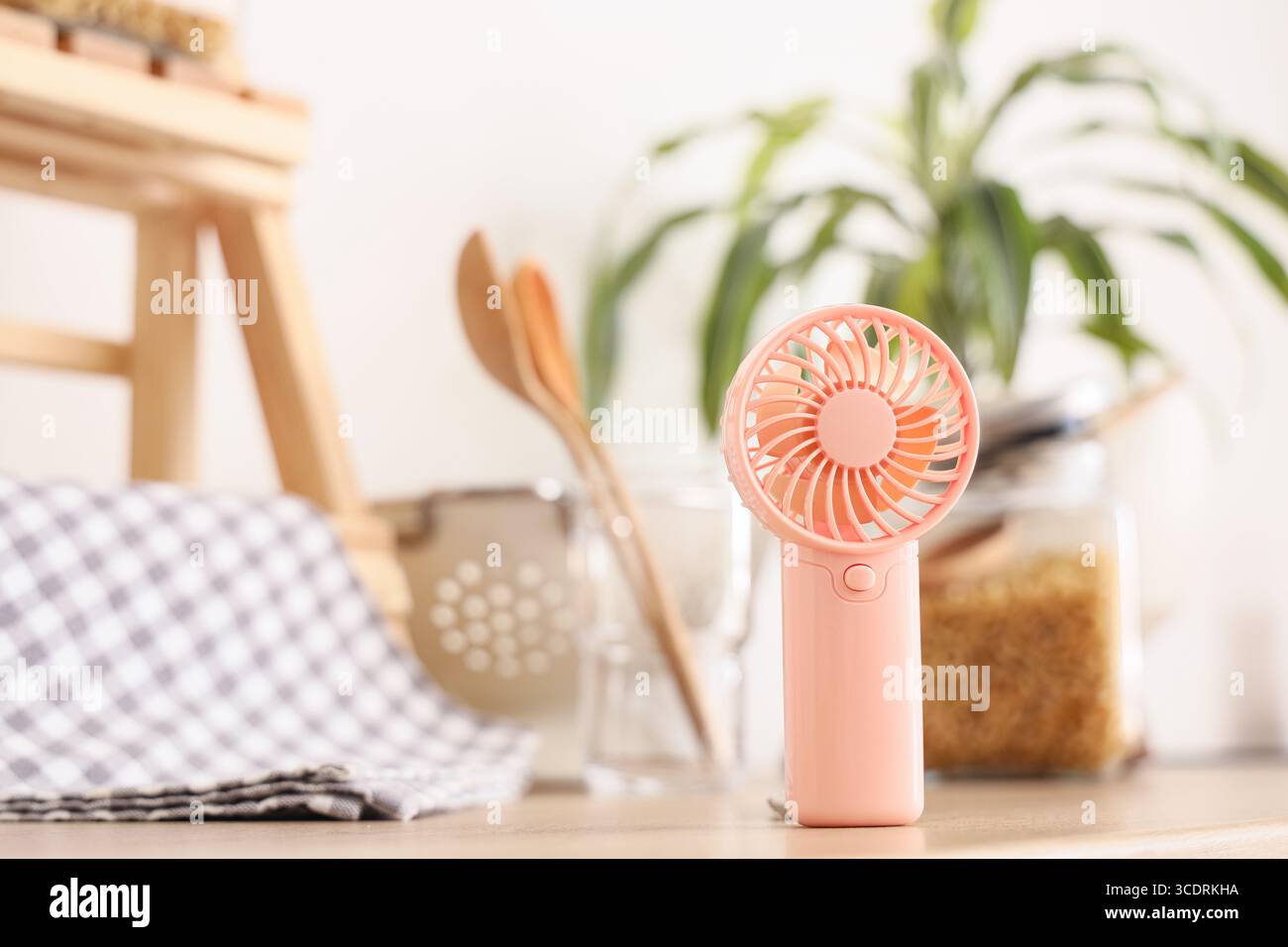 Mini fan on counter in kitchen, closeup Stock Photo