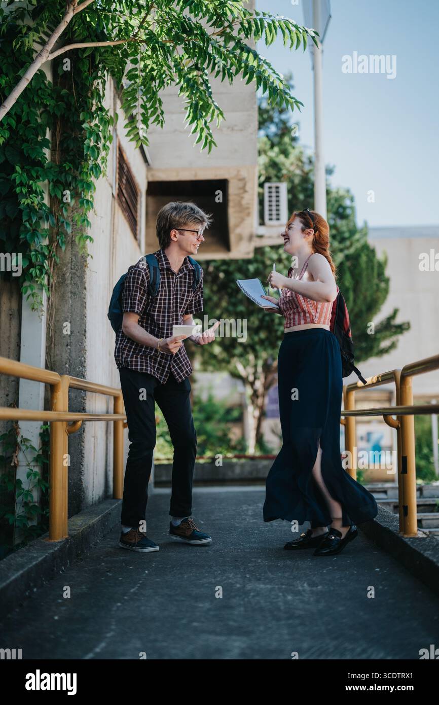 Students interacting and having a conversation in a school courtyard setting Stock Photo