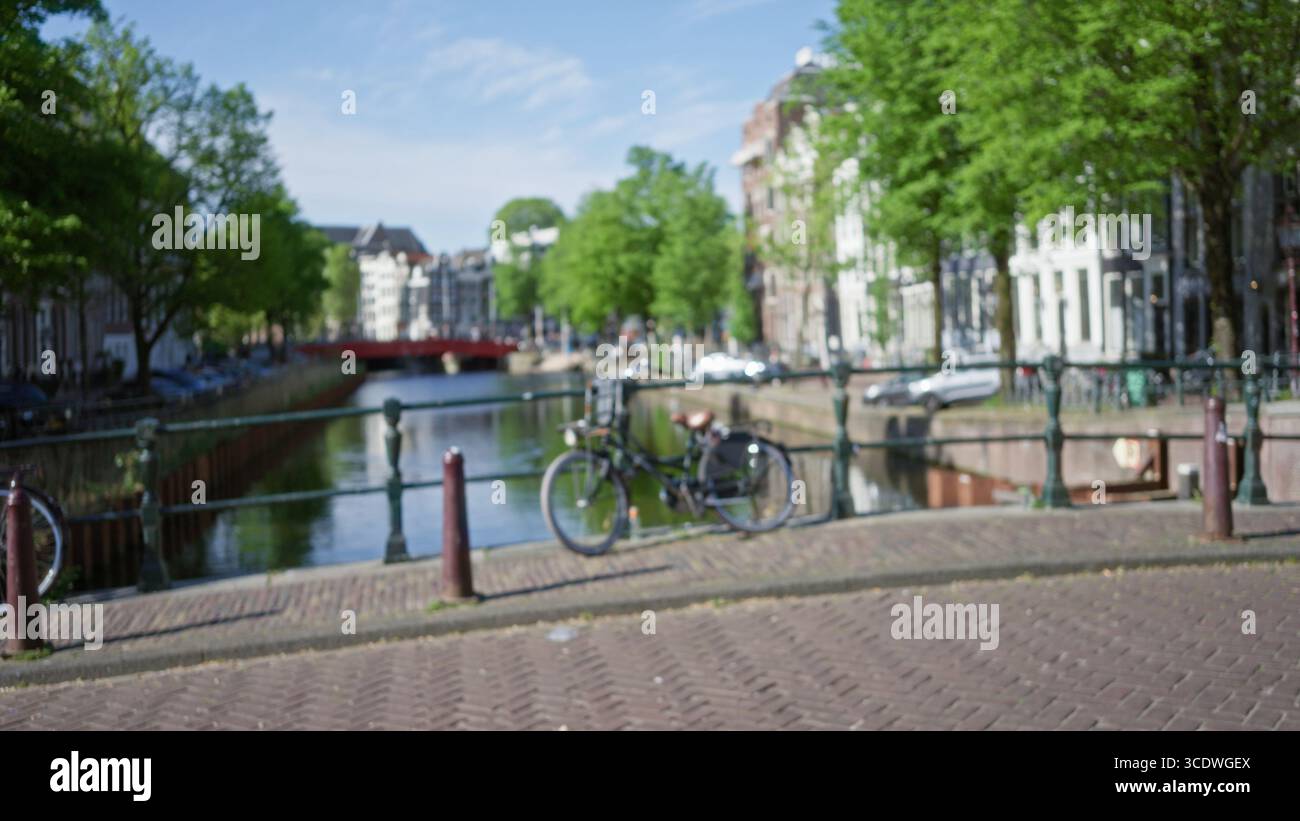 Blurred view of amsterdam's iconic canals with bicycles, showcasing ...