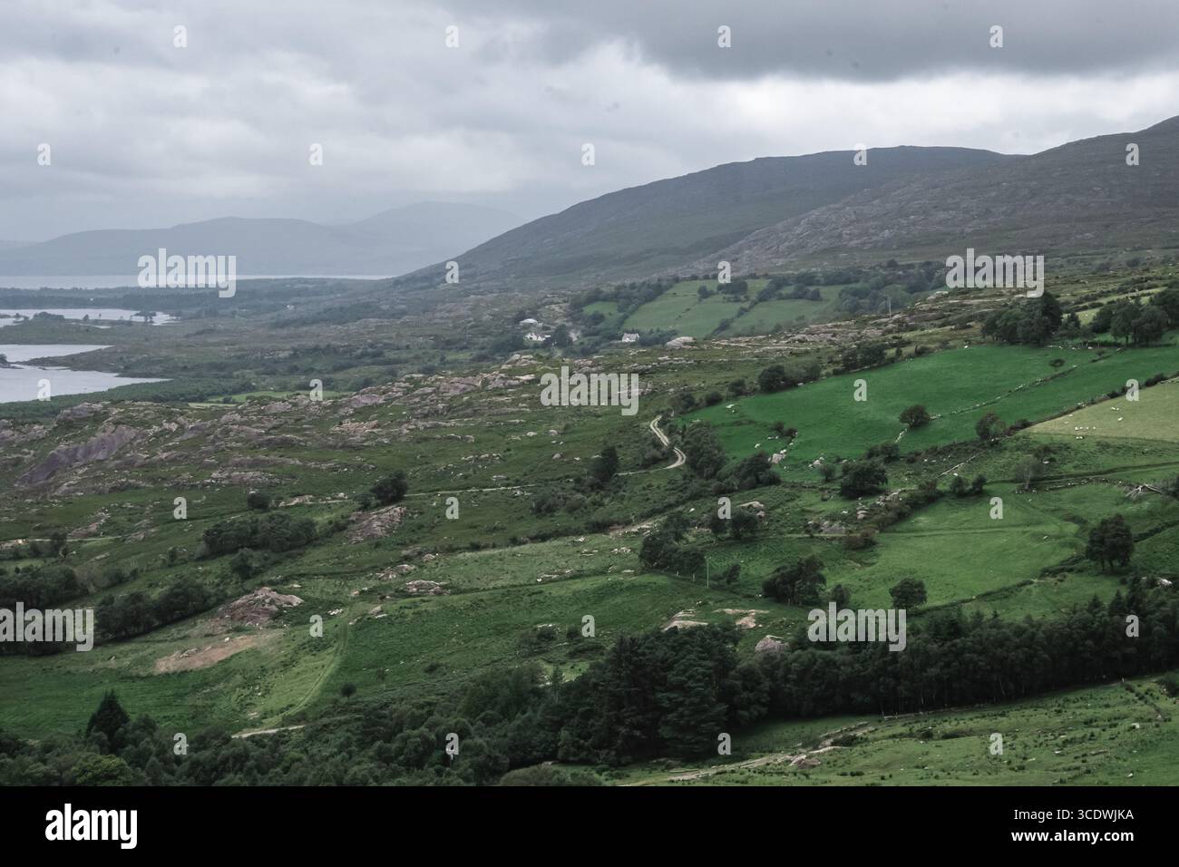 A Serene Green Landscape Featuring Lush Fields Under Expansive Cloudy ...