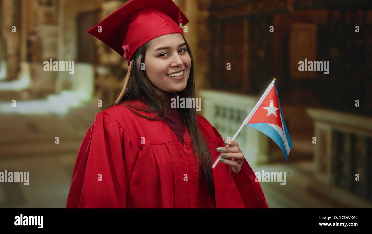 Cuban Graduation Woman celebrating graduation holds cuban flag in a church setting ...
