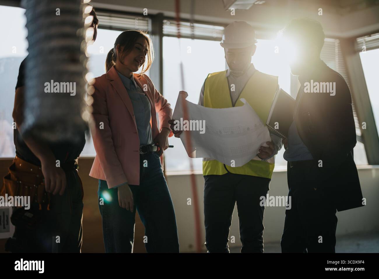 Construction Professionals Collaborating at a Building Site During Daylight Stock Photo