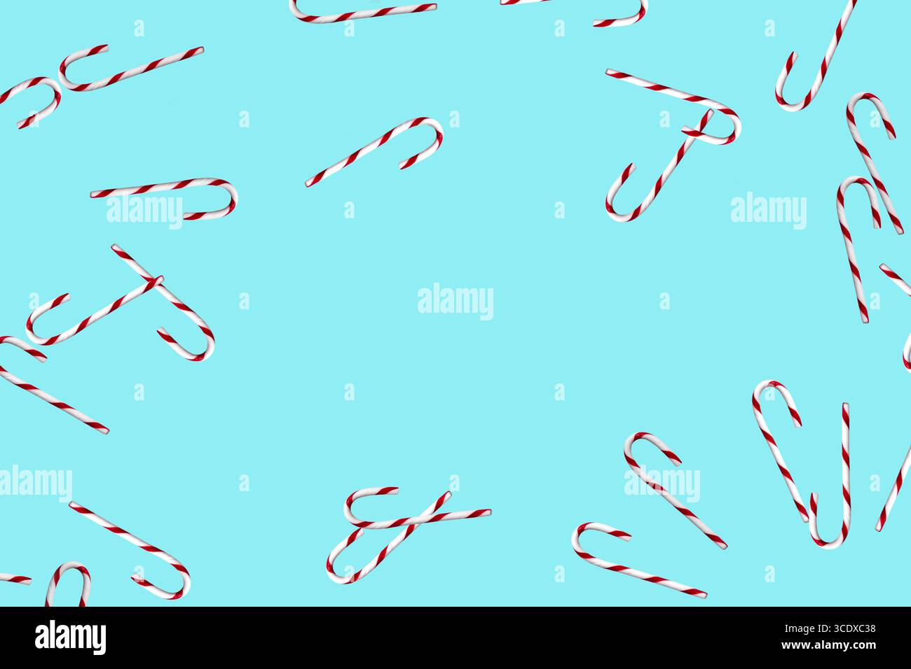 Random candy canes on light blue background Stock Photo