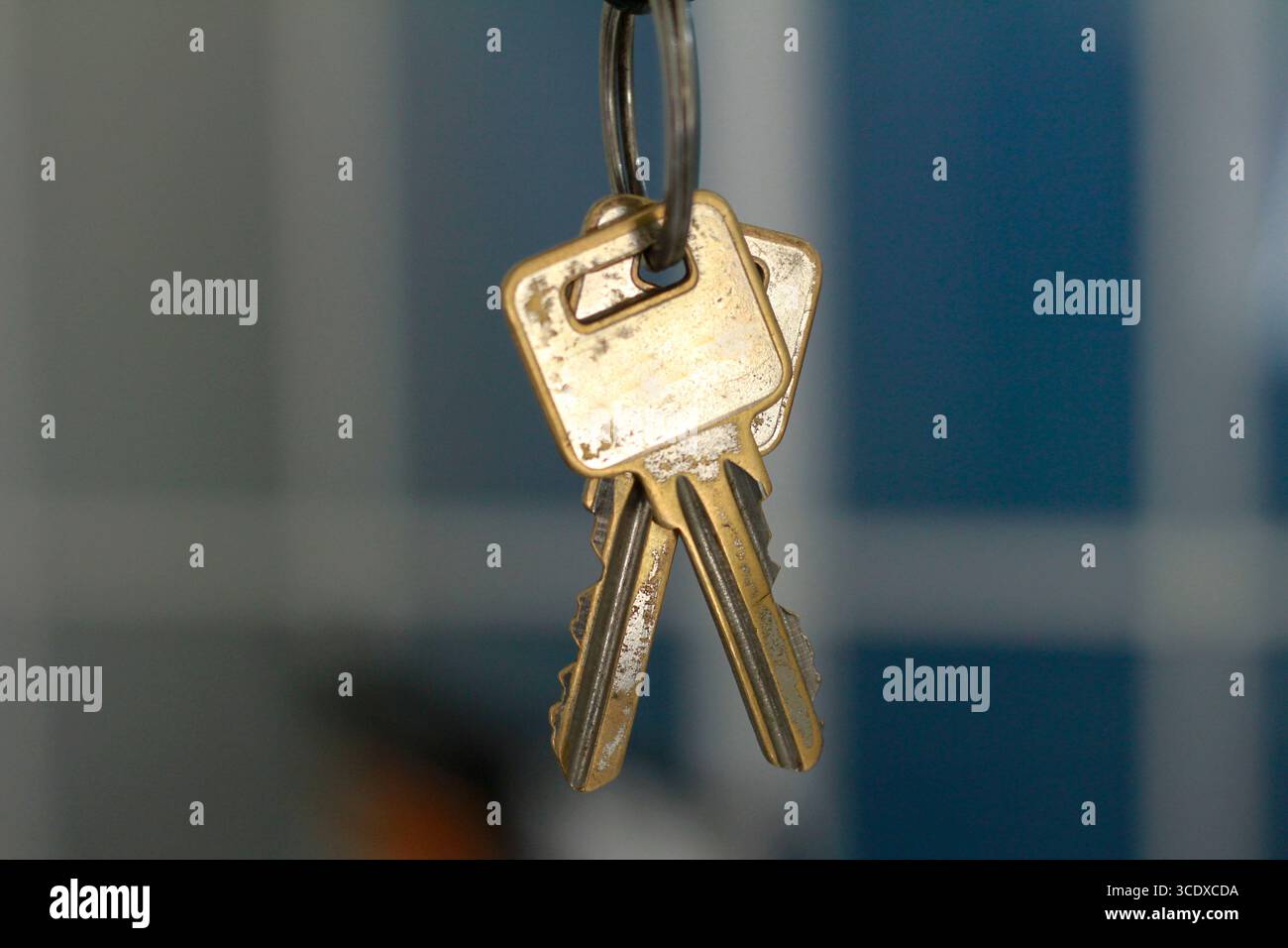 The key hangs on a black background. Stock Photo