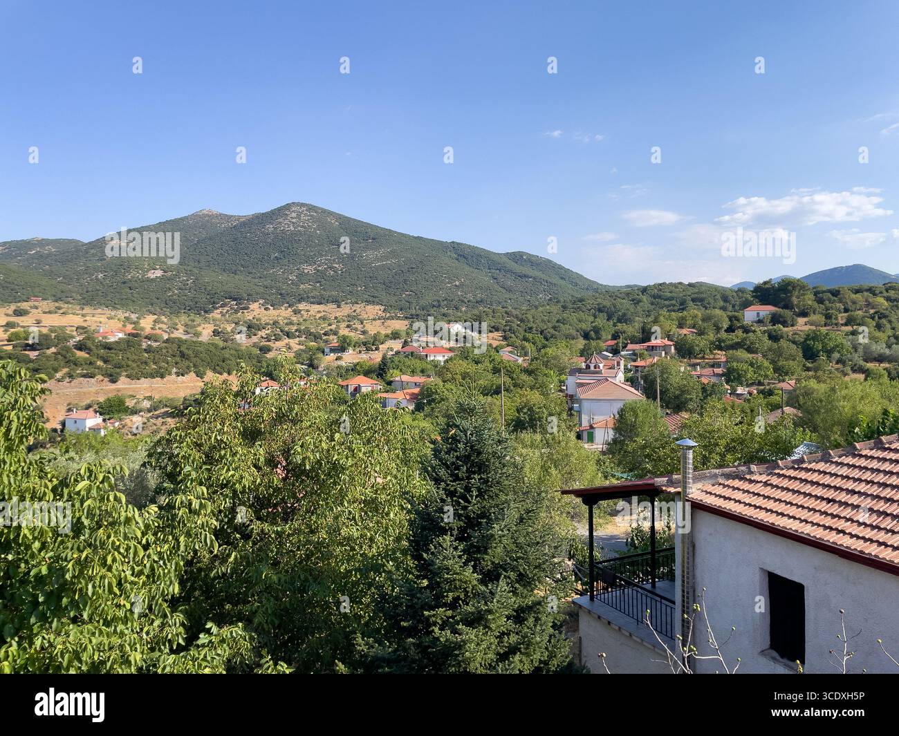 Sunlit village rooftops and rolling green hills in Drakovouni, Arcadia — a serene slice of Greece’s timeless countryside. - Smartphone Captured Stock Image