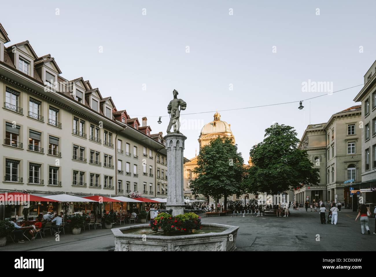 07-08-2025 Bern, Switzerland. Famous Barenplatz square with people and restaurant. Sunny summer evening, Parliament building in the background, wide a Stock Photo
