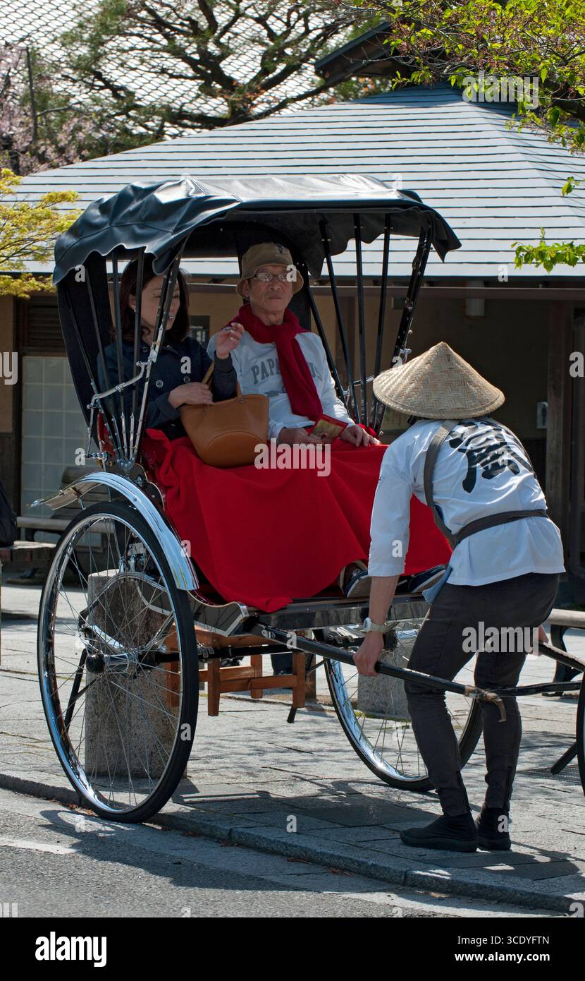 Tourists take a ride in a traditional 
